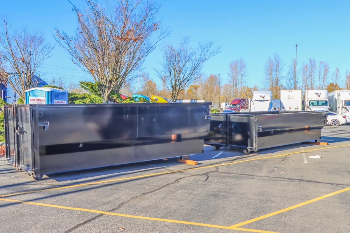Professional dumpster rental service with roll-off container on residential driveway in Lackawaxen